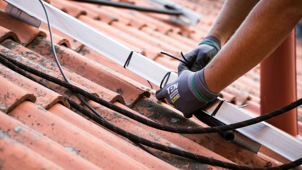 worker on roof making repairs Lincoln exteriors 