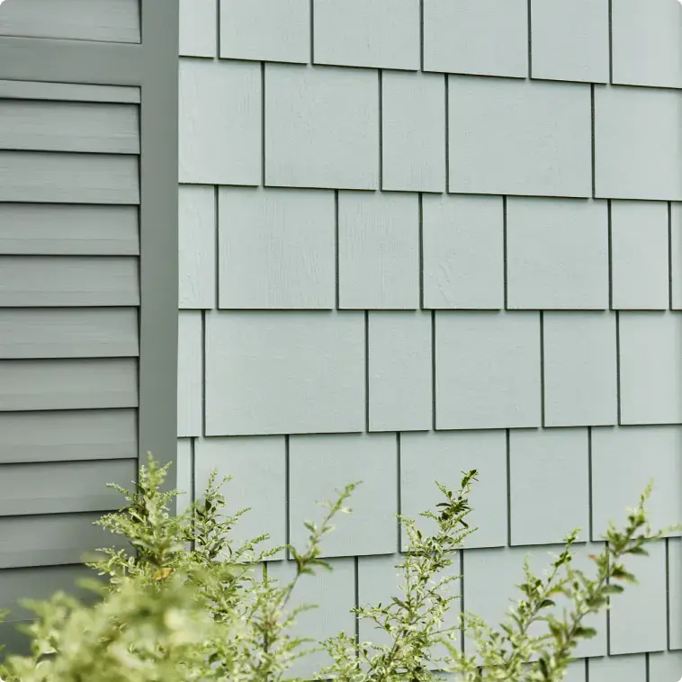 Lincoln Exteriors - James Hardie 39 Lincoln Exteriors Calgary James Hardie Siding Magnolia with window shutters and shrubs